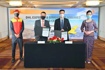 Ken Lee, CEO, DHL Express Asia Pacific and Lee Lik Hsin, Executive Vice President Commercial, Singapore Airlines have signed an agreement to deploy five Boeing 777 freighters, which will be operated and maintained by SIA. Photo: Singapore Airlines