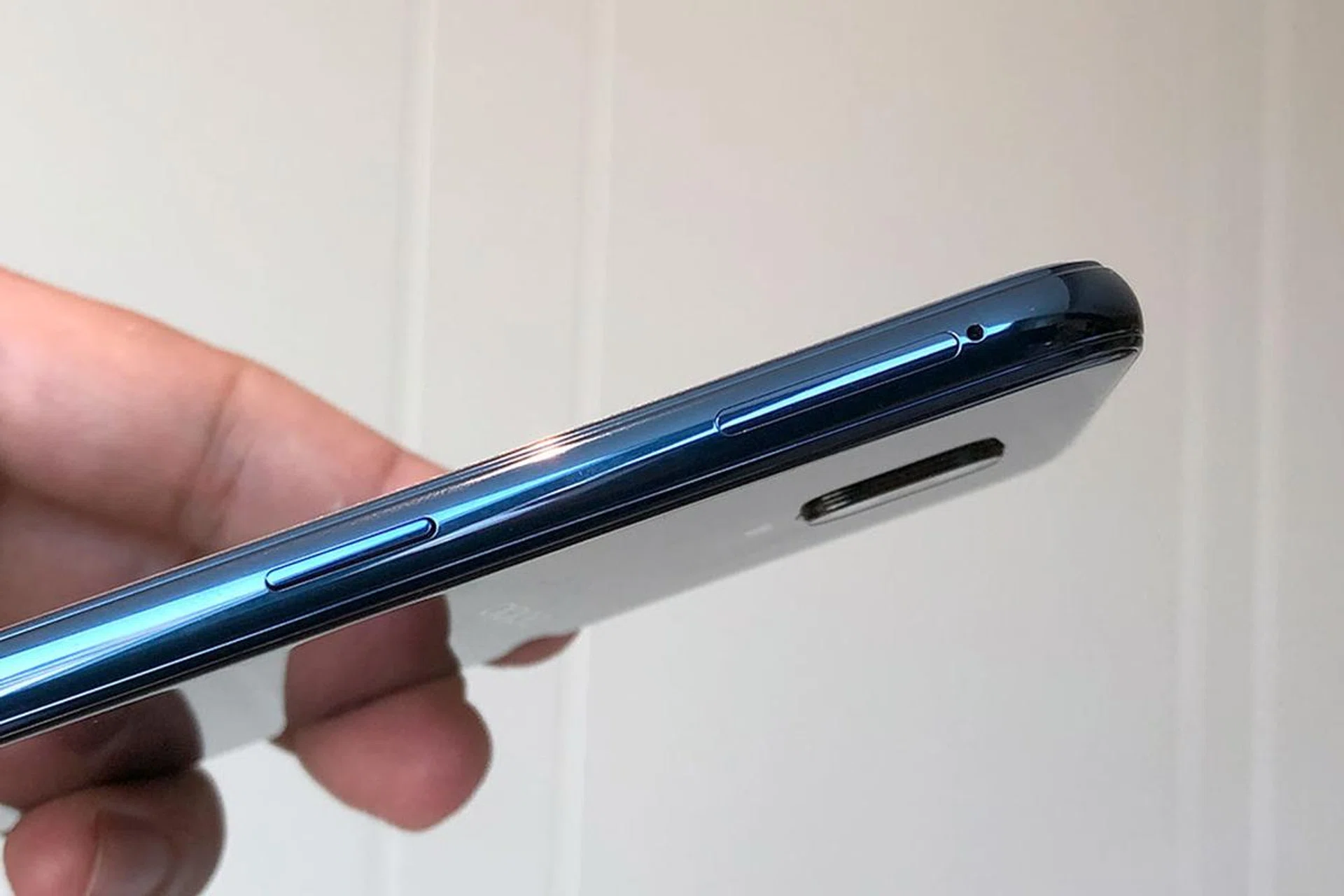 The power button and SIM tray are located on the right, while the volume controls are on the left.