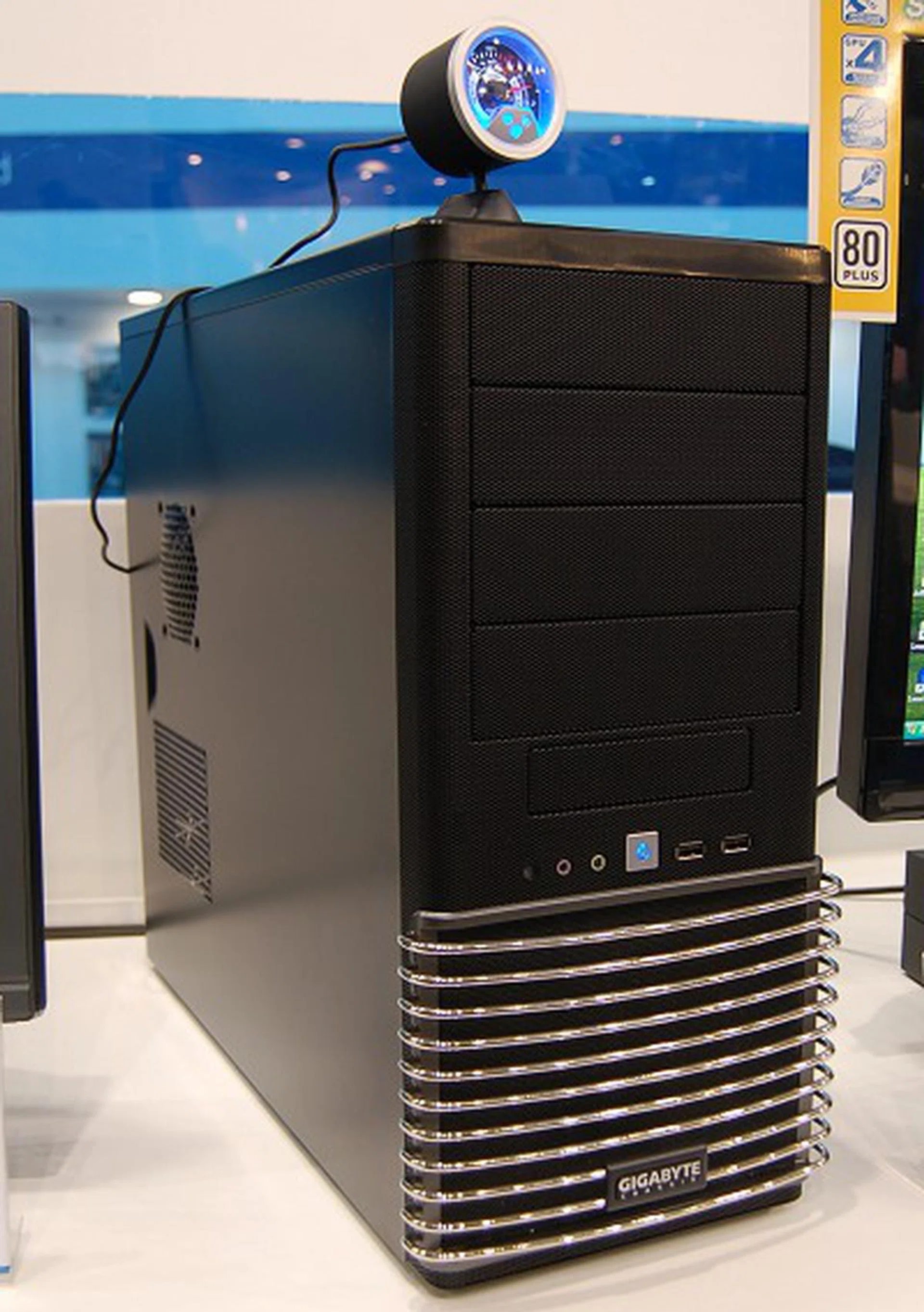  This is the Gigabyte Setto 1024 casing. It's completely made from steel including the bars in front. It comes with two 120mm fans, cable management and boasts of tool-free installation. The funky gadget above is an optional visual USB gauge from Gigabyte that interfaces with their ODIN GT PSUs.  