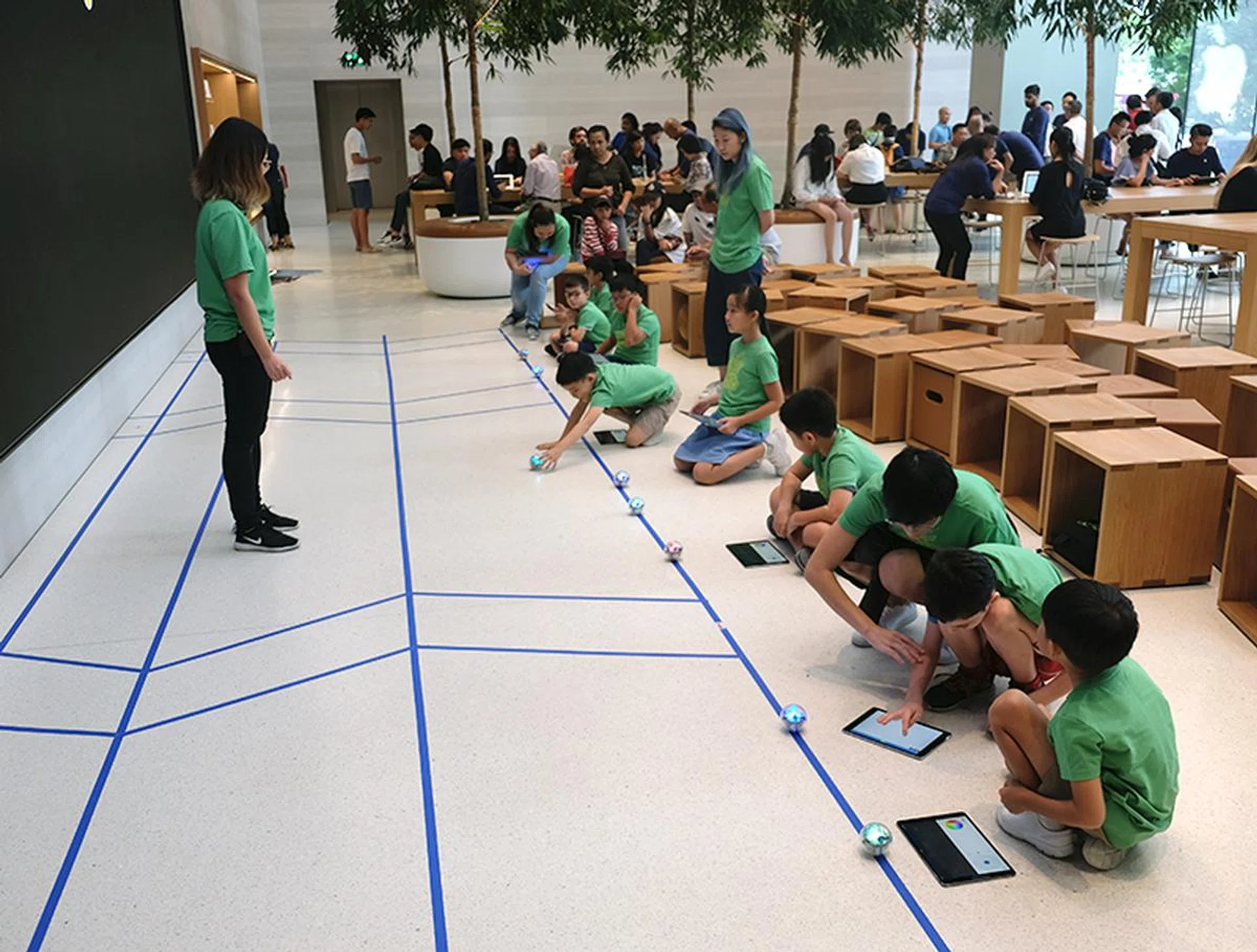 Children lining up their Sphero robots on the starting line to begin the second mission.