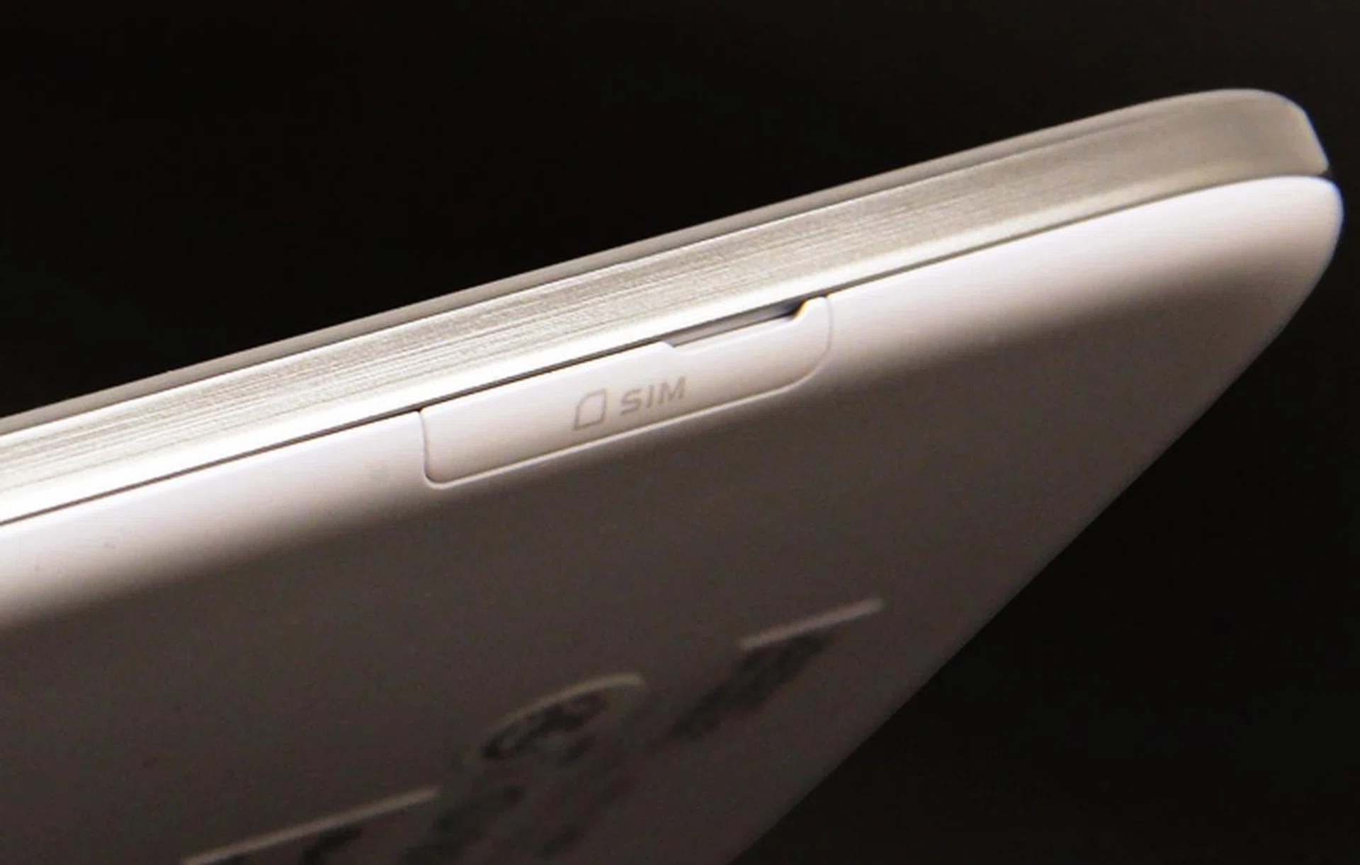 On the left edge, the micro-SIM and microSD memory card slots are hidden behind plastic flaps.