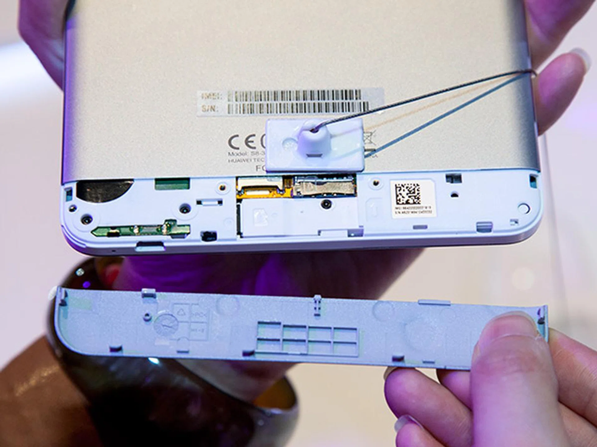 The microSD and SIM card slots can be accessed through a removable panel located at the lower rear portion of the tablet.