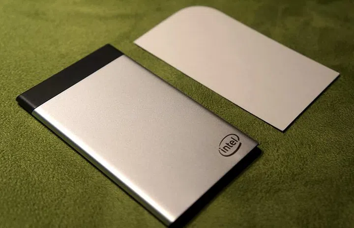 The Intel Compute Card sample laid next to a name card.