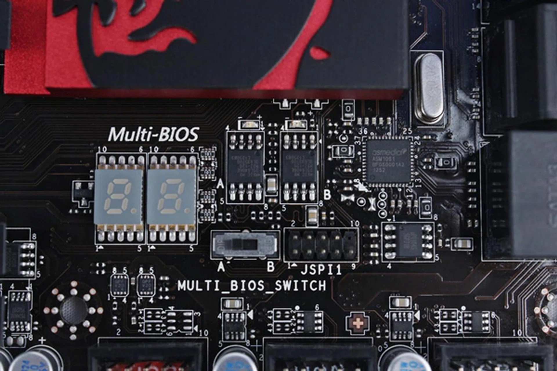 The Multi-BIOS switch is located near the edge of the heatsink of the chipset, behind the stack of SATA connectors.