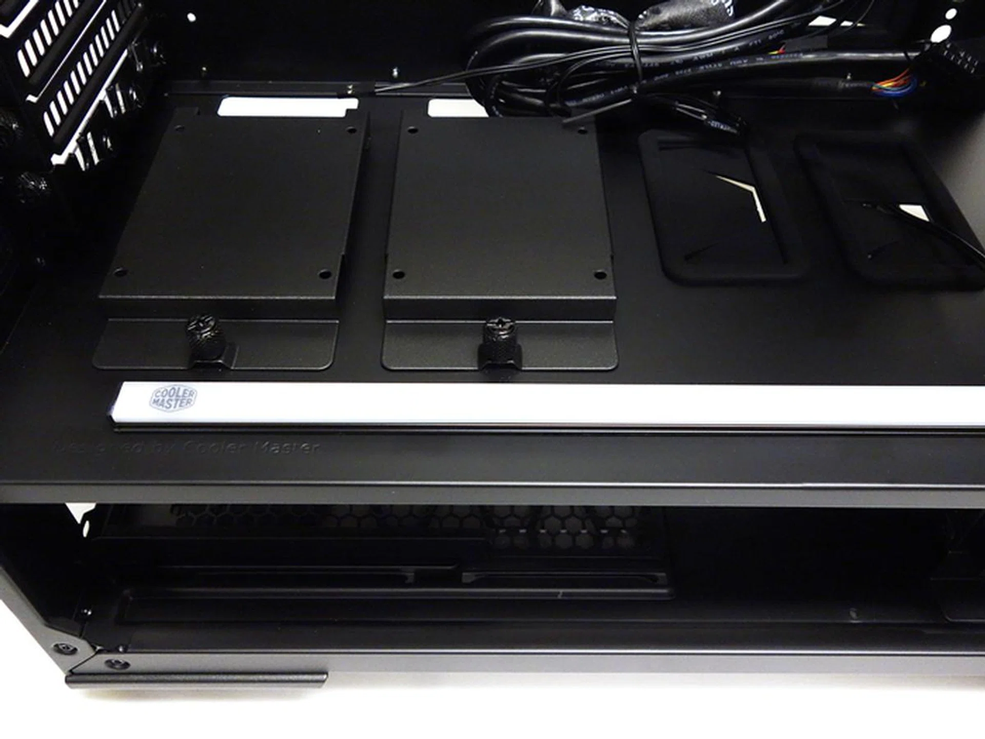 This is the LED strip with a magnetic back for easy attachment. Beyond the strip, we see a pair of 2.5-inch drive trays.