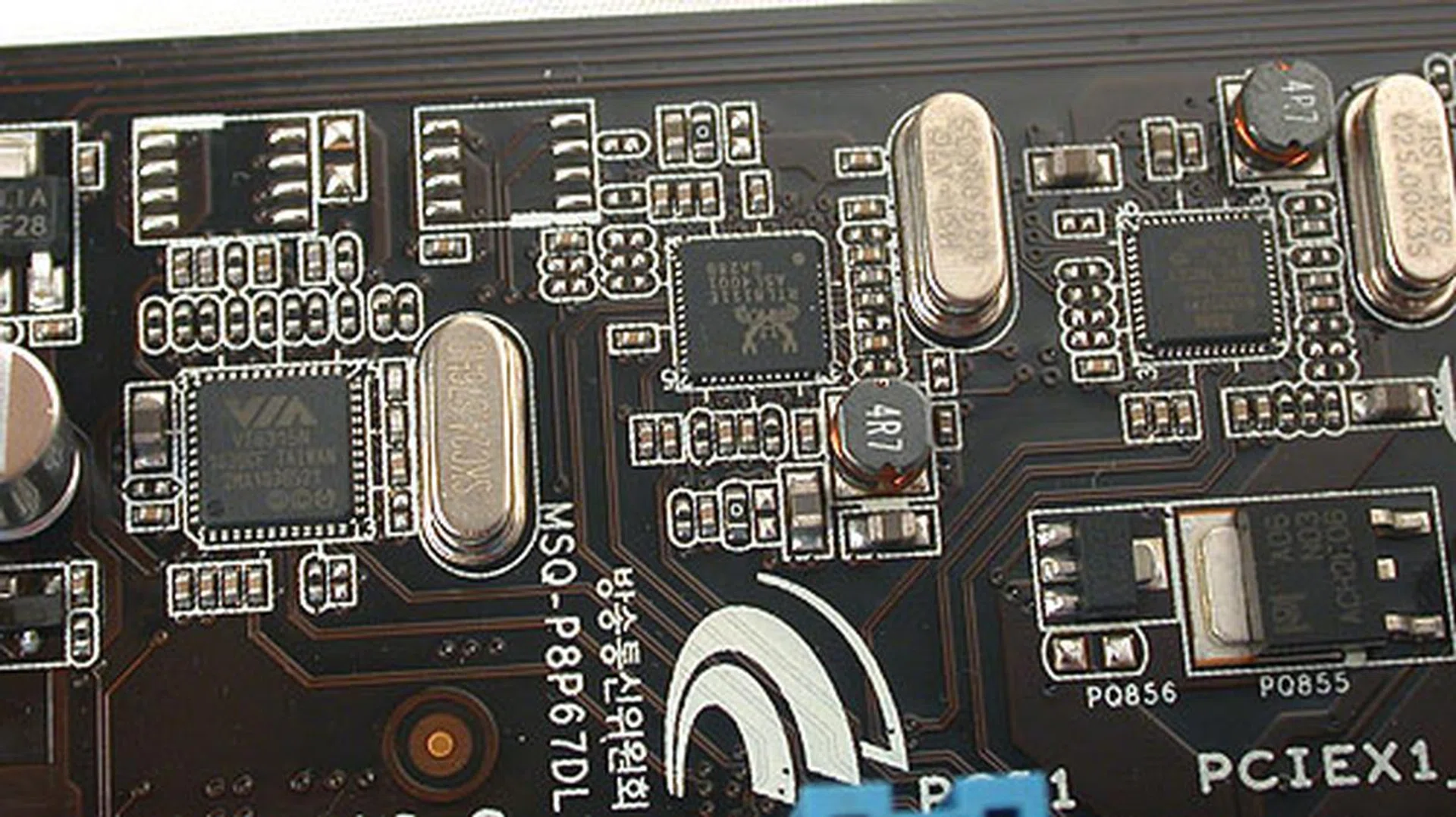 Near the rear of the board are clustered the onboard controllers for features like HD audio (Realtek), FireWire (VIA) and Ethernet.