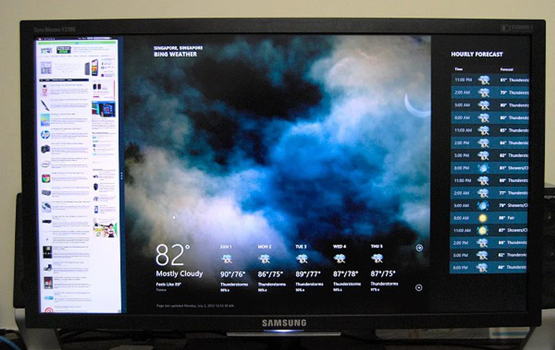 Having HardwareZone open in IE10 on the side tab while launching the weather app in the foreground.