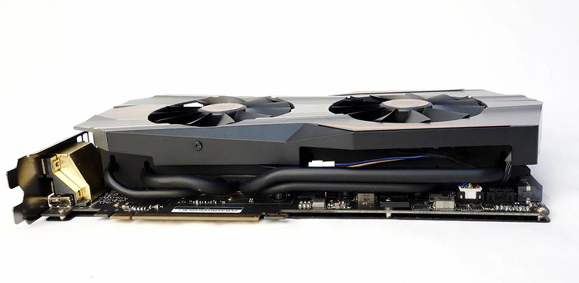 With the card resting on its backplate, we can see the snaking black heatpipes of its DirectCU II heatsink. According to ASUS, the entire heatsink has been painted black except its plate that's in direct contact with the GM200 GPU.