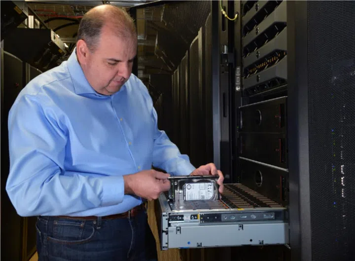 Ed Fiore, VP of engineering for Dell storage, inspecting a new Dell Compellent SC280 super dense data storage enclosure. (Image credit: Dell.)