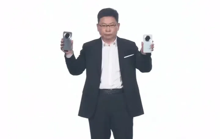Richard Yu, CEO of Huawei, holding up two Mate 70 series devices for the audience. Image: Huawei.