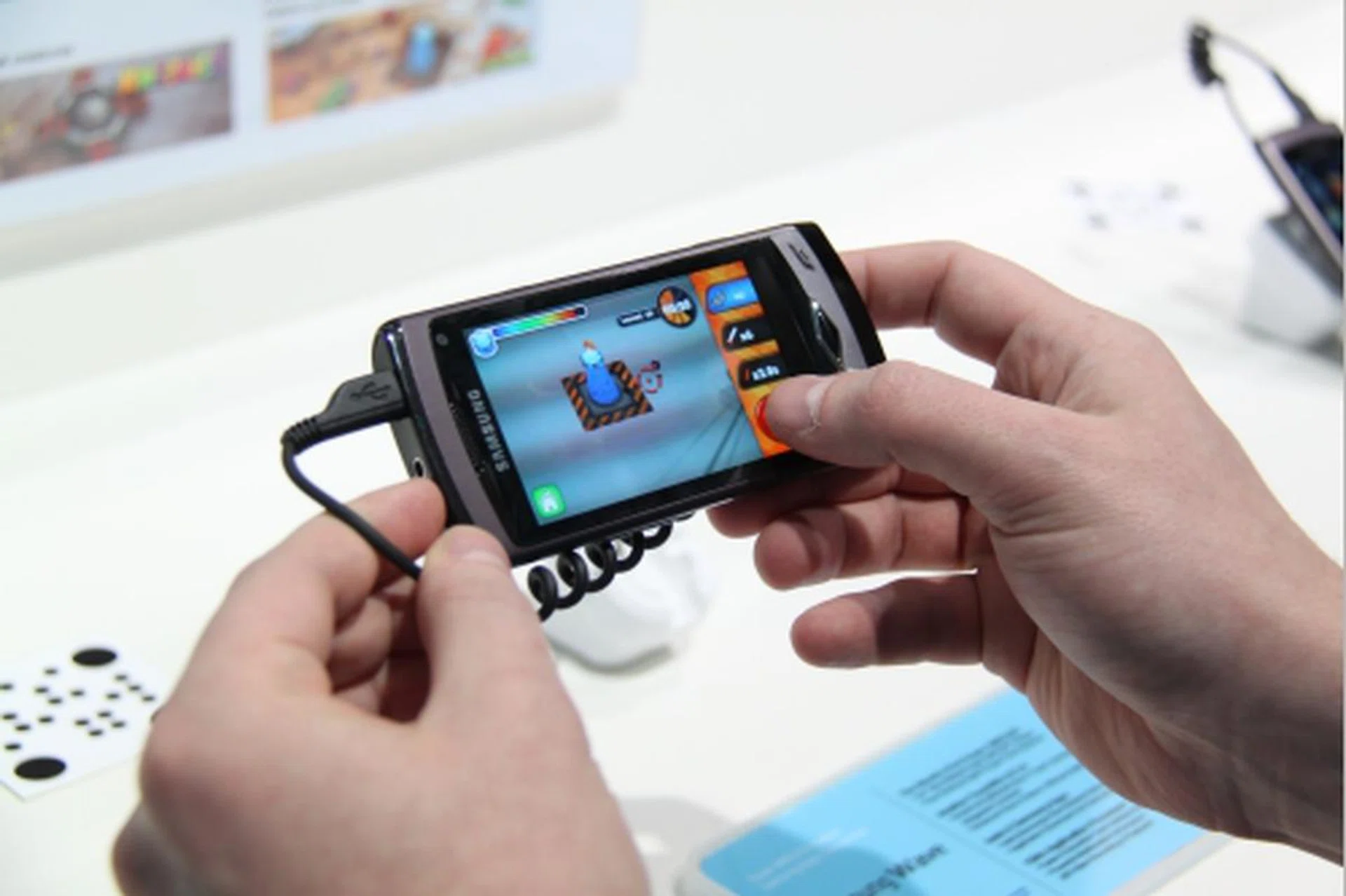 One of the Samsung Apps shown at MWC are two augmented reality games -- Kweekies and ARDefencer. Both utilize the camera on the Wave where by snapping a particular patterned square, certain items (be it a virtual character or a defensive tower type) will appear for you to interact with.