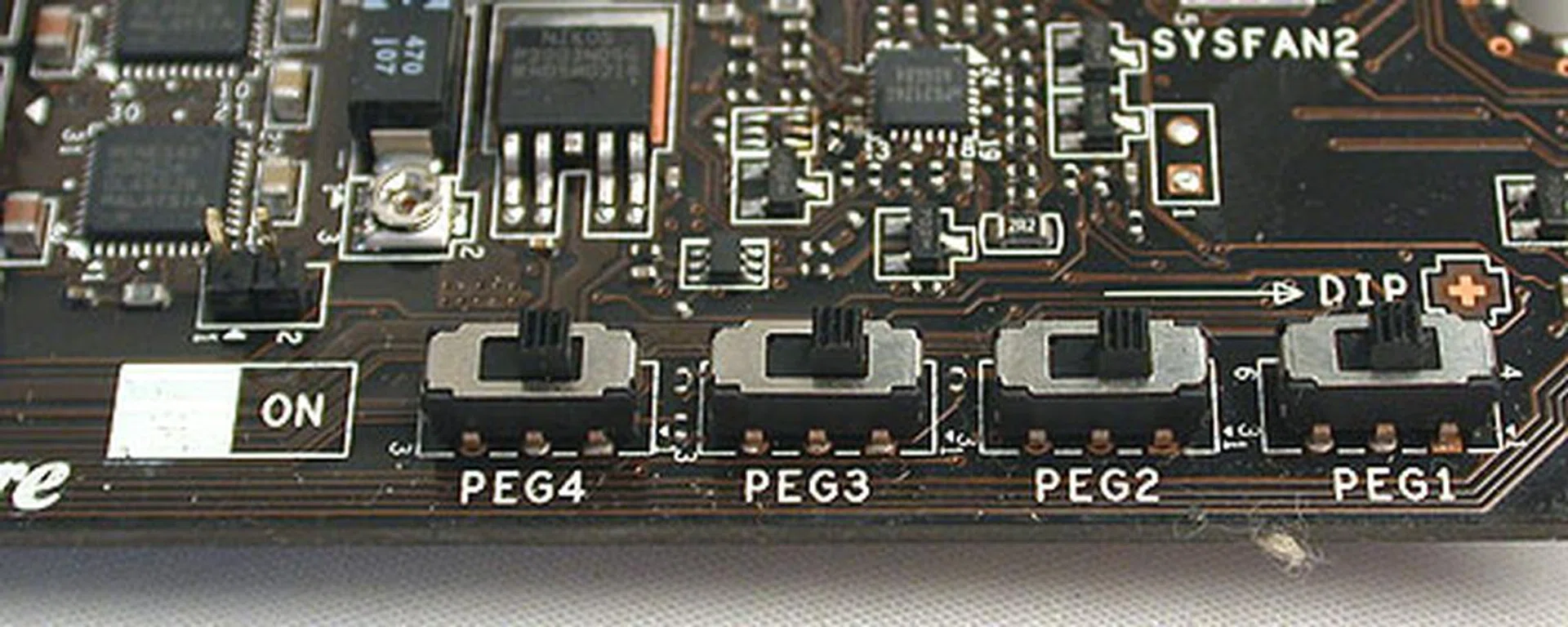 These are what MSI calls PCIe CeaseFire, physical switches that allow users to turn off the four PCIe x16 slots for the graphics cards. It's similar to what we saw on the ASUS Maximus IV Extreme earlier. Of course, don't try turning them on or off when there's current, as this will damage the board.