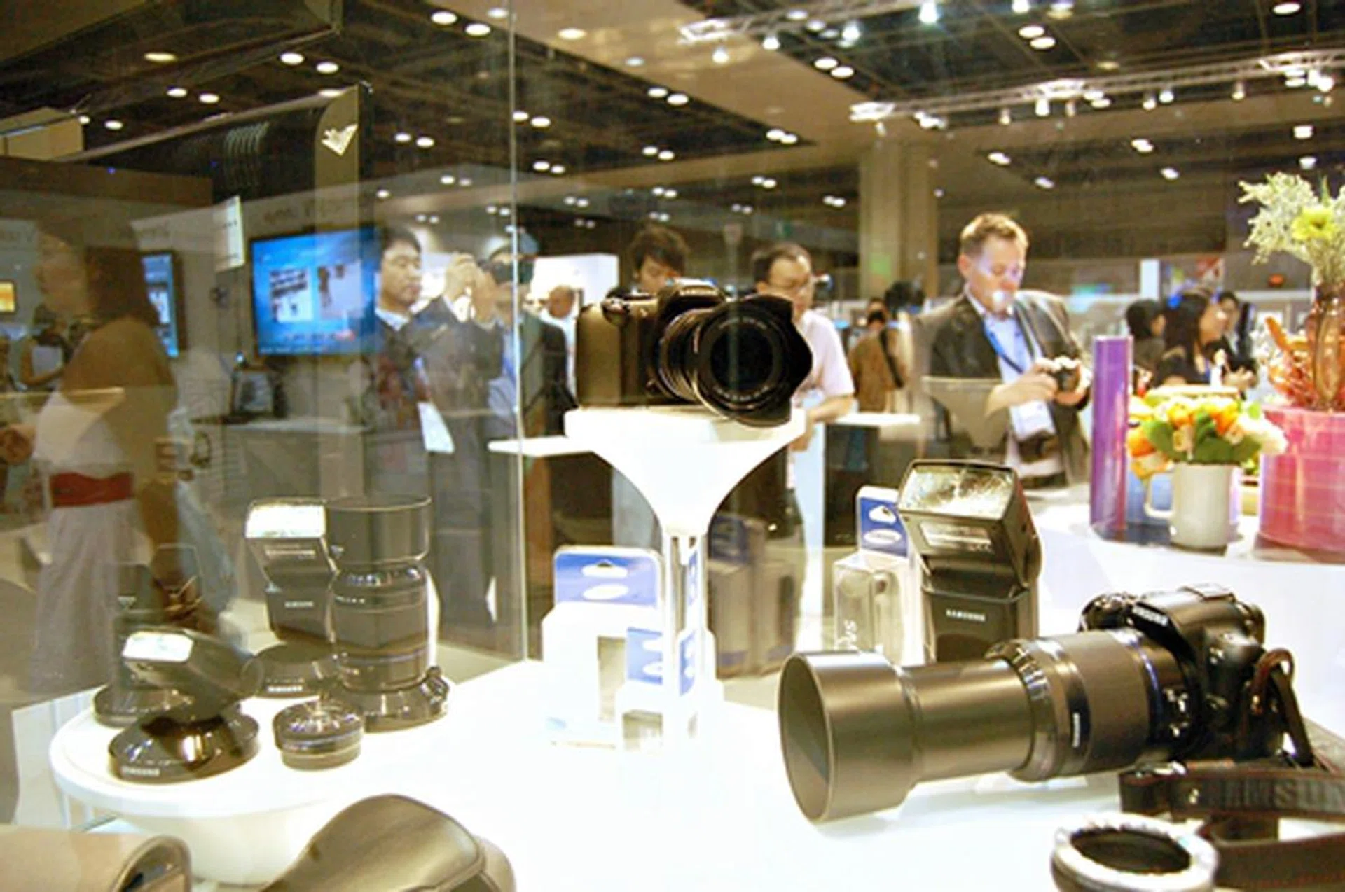 The NX10 displayed here in all its glory surrounded by upcoming to-be-released accessories like flashes, camera holsters, bags and lenses. 