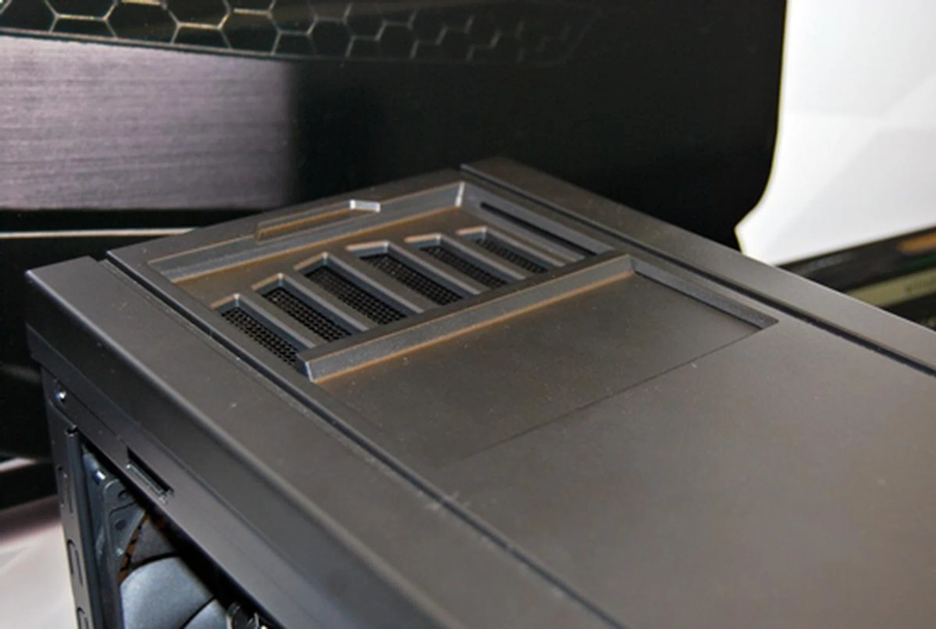 There is a cover that slides back to review a vent for an additional rear fan.