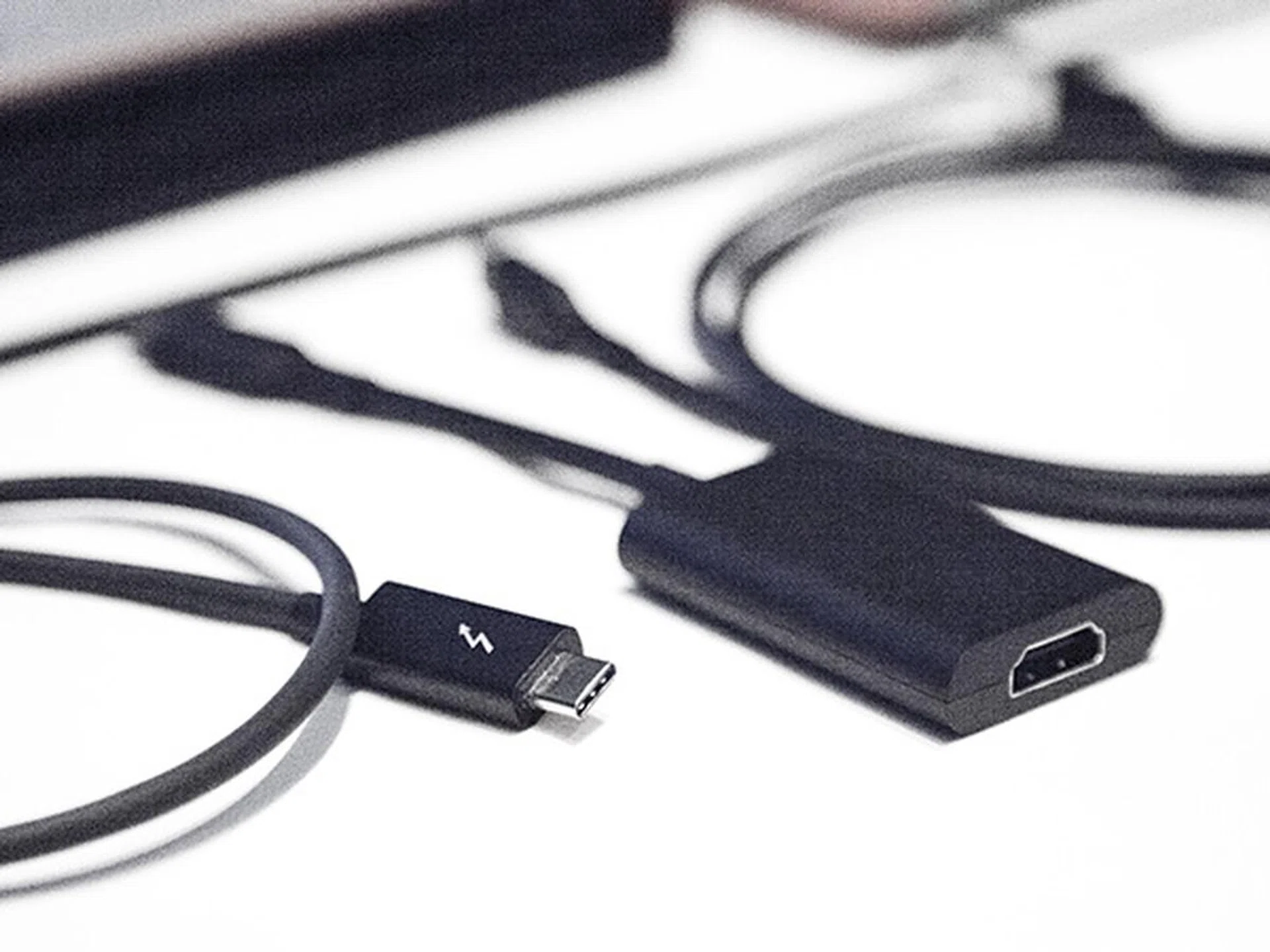 Although the new Thunderbolt 3 cable comes with the same connector as USB-C, you can quickly tell it's made for Thunderbolt by the lightning symbol on the plug. Also seen here is a Thunderbolt 3 to HDMI connector (on the right).