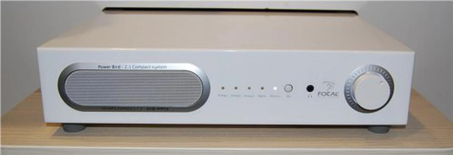 The front shows a vent for the sound and the volume knob, along with a display for the channel selected. The Power Bird is available in a black or white finish.