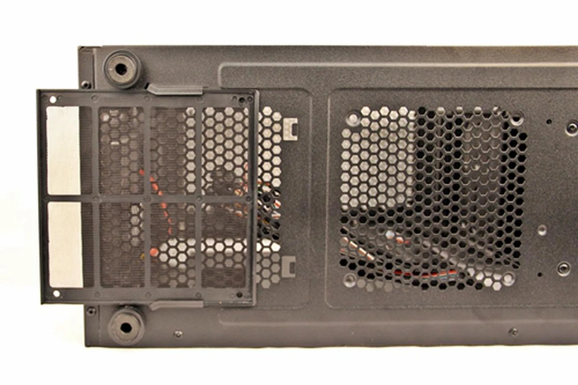 The washable dust filter for the air vents of the PSU; to its right are the air vents for the optional bottom 120mm cooling fan.