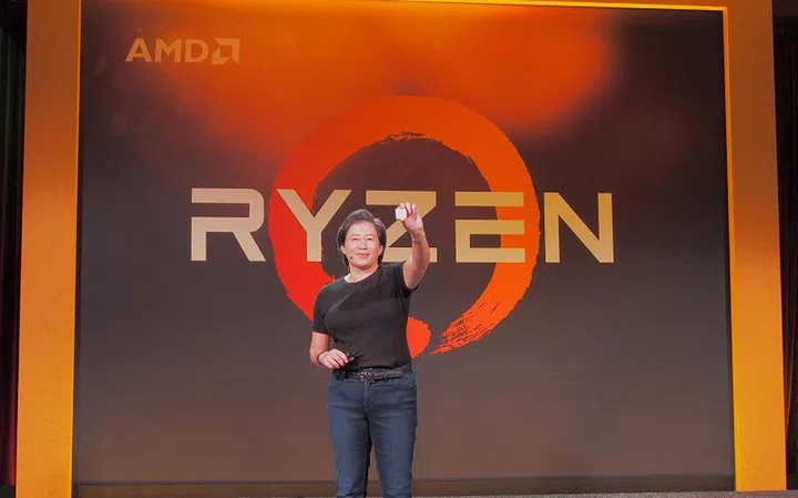 Dr.Lisa Su, President and CEO of AMD holding out an AMD Ryzen CPU, which is available for pre-order immediately.