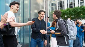 John Ternus welcomes a customer at Apple Fifth Avenue in New York for the launch of the latest generation of iPhone, Apple Watch, and AirPods.