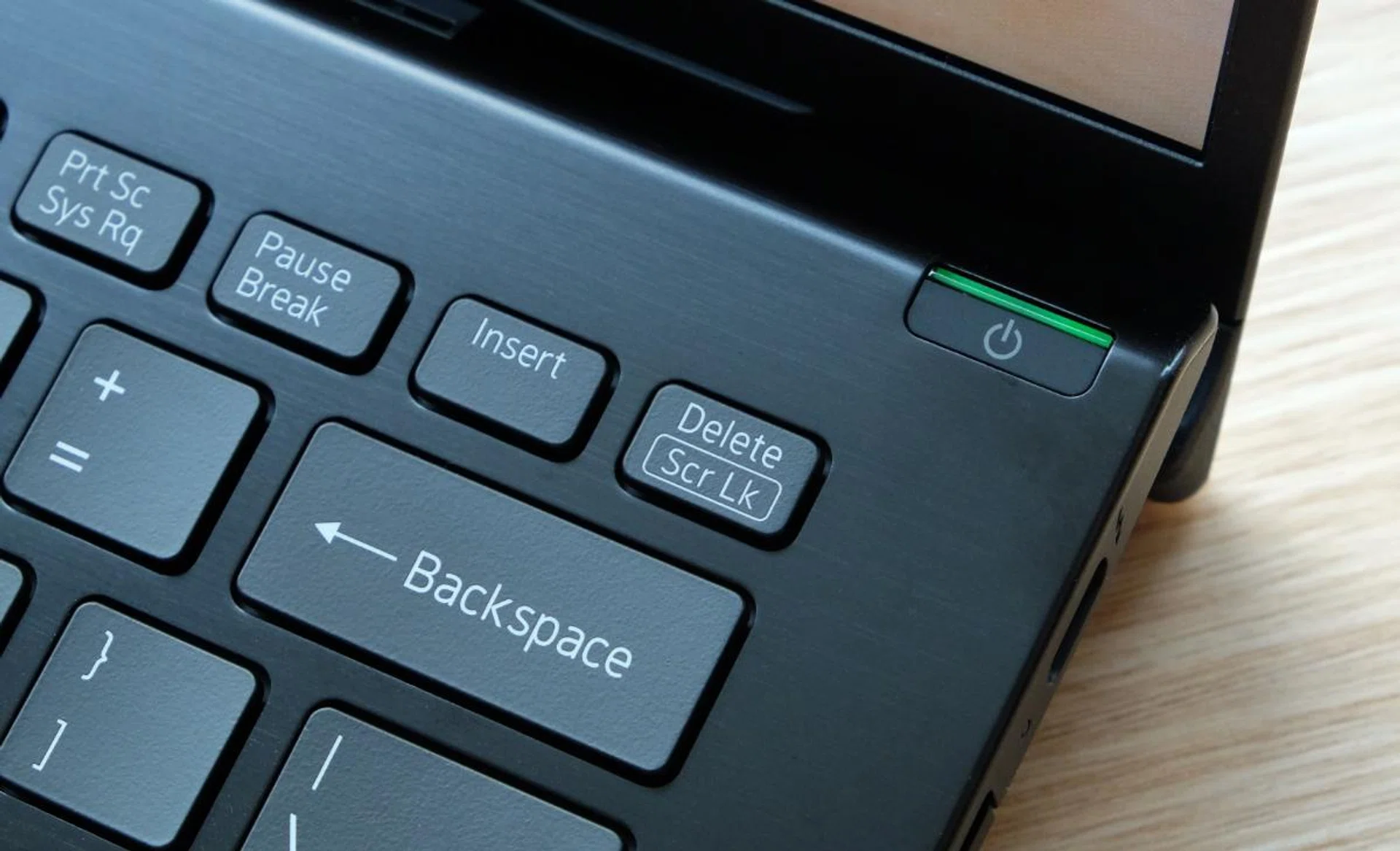 The power button has a bright green LED indicator. It also doubles up as a fingerprint scanner.