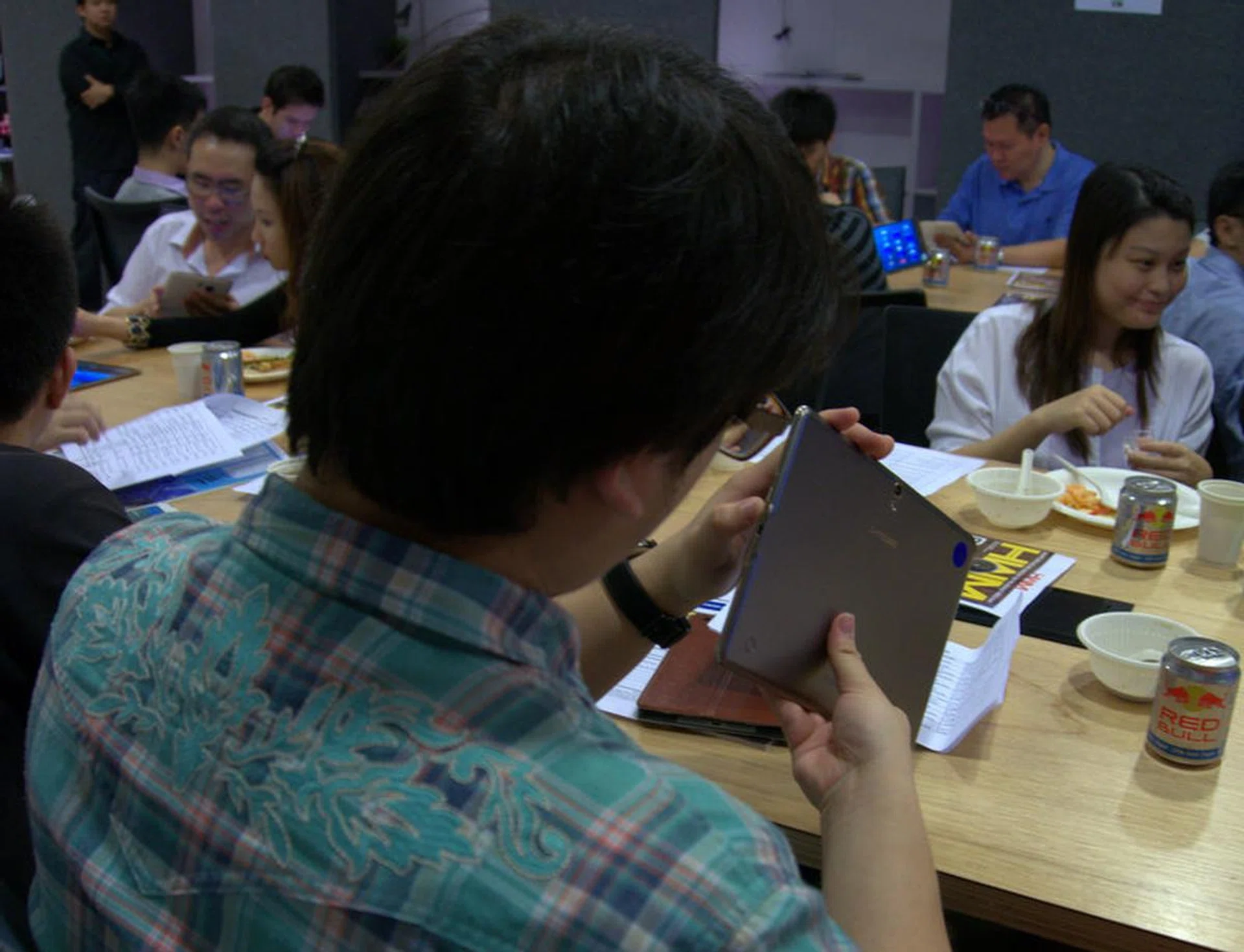 An attendee taking a good look at the physical features and design of the Samsung Galaxy Tab S (10.5) model.