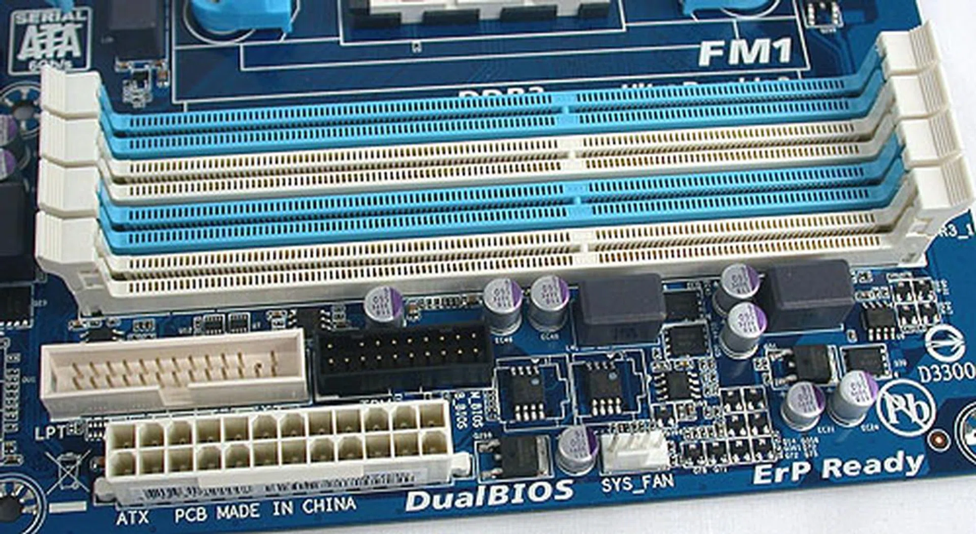 Up to 32GB worth of DDR3 1866MHz memory modules can be installed. Almost hidden below the DIMM slots is a TPM header in black and a parallel port header. 