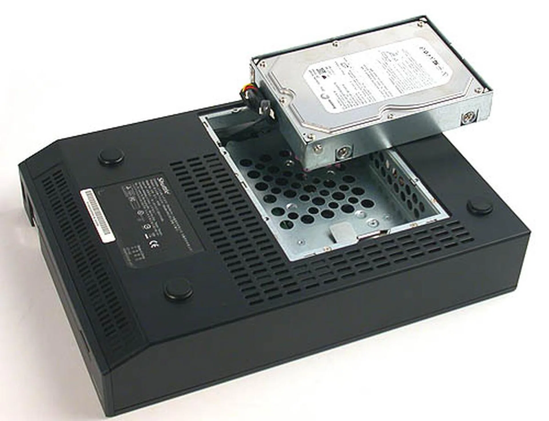 Flip over the XPC and unscrew the bottom section to change the pre-installed Seagate 250GB SATA hard drive. This is a standard hard drive that you can buy from stores and it's relatively easy to change it to a larger capacity. Of course, you can only have one hard drive at any time.