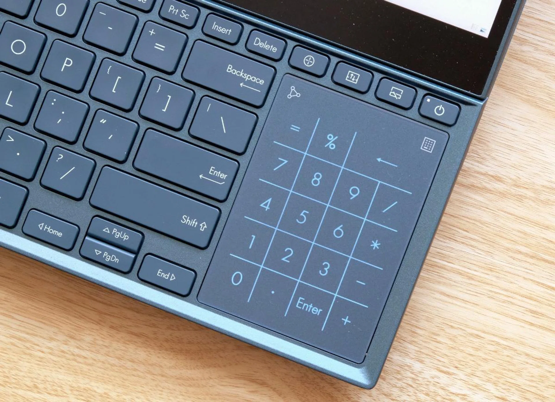 At the press of a button (see the little icon in the top right?), the trackpad doubles up as a numpad