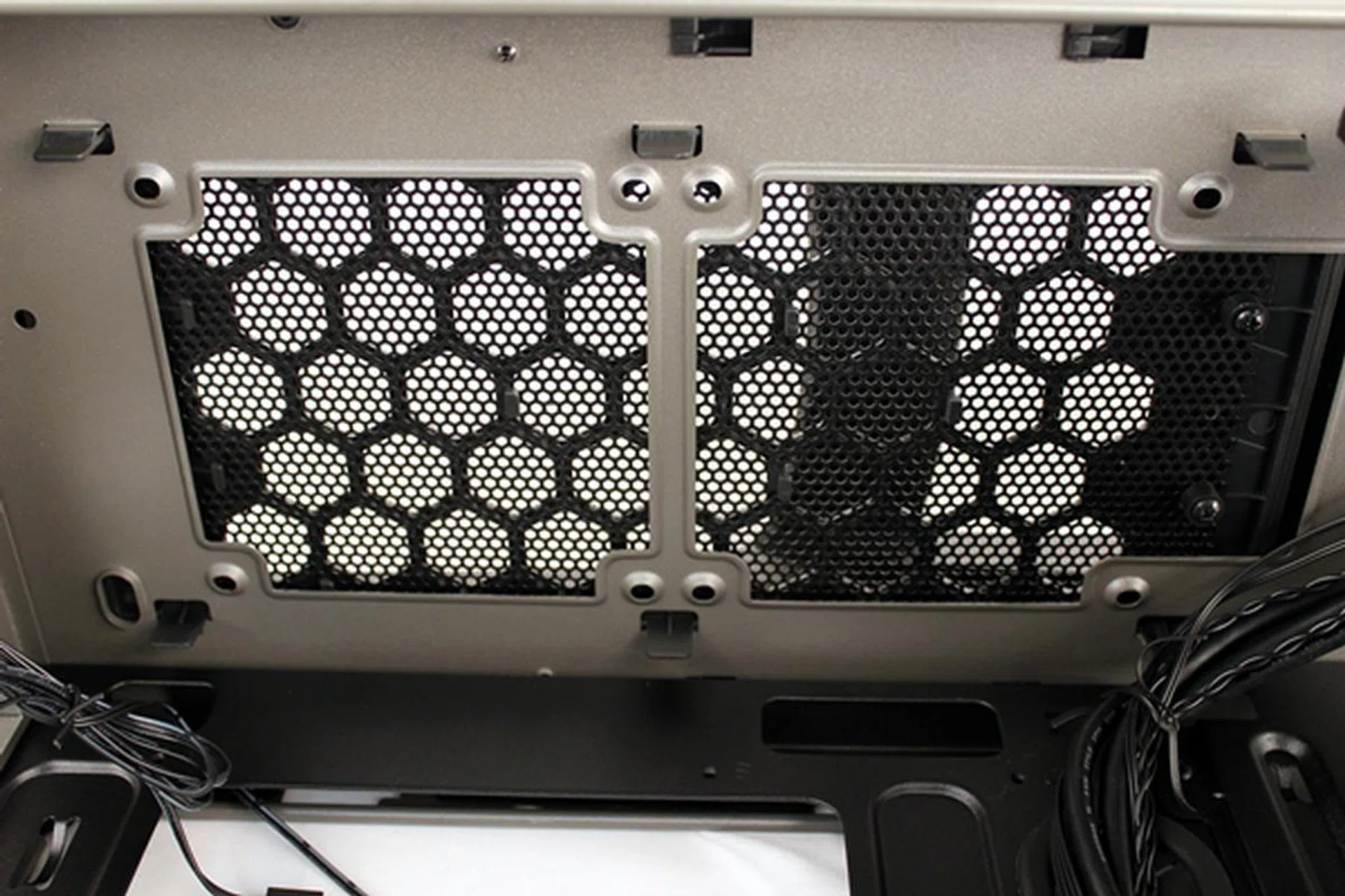 The top panel cooling options allow for a pair of 120mm fans. The removable cover is held in place over the cooling options by six tabs.