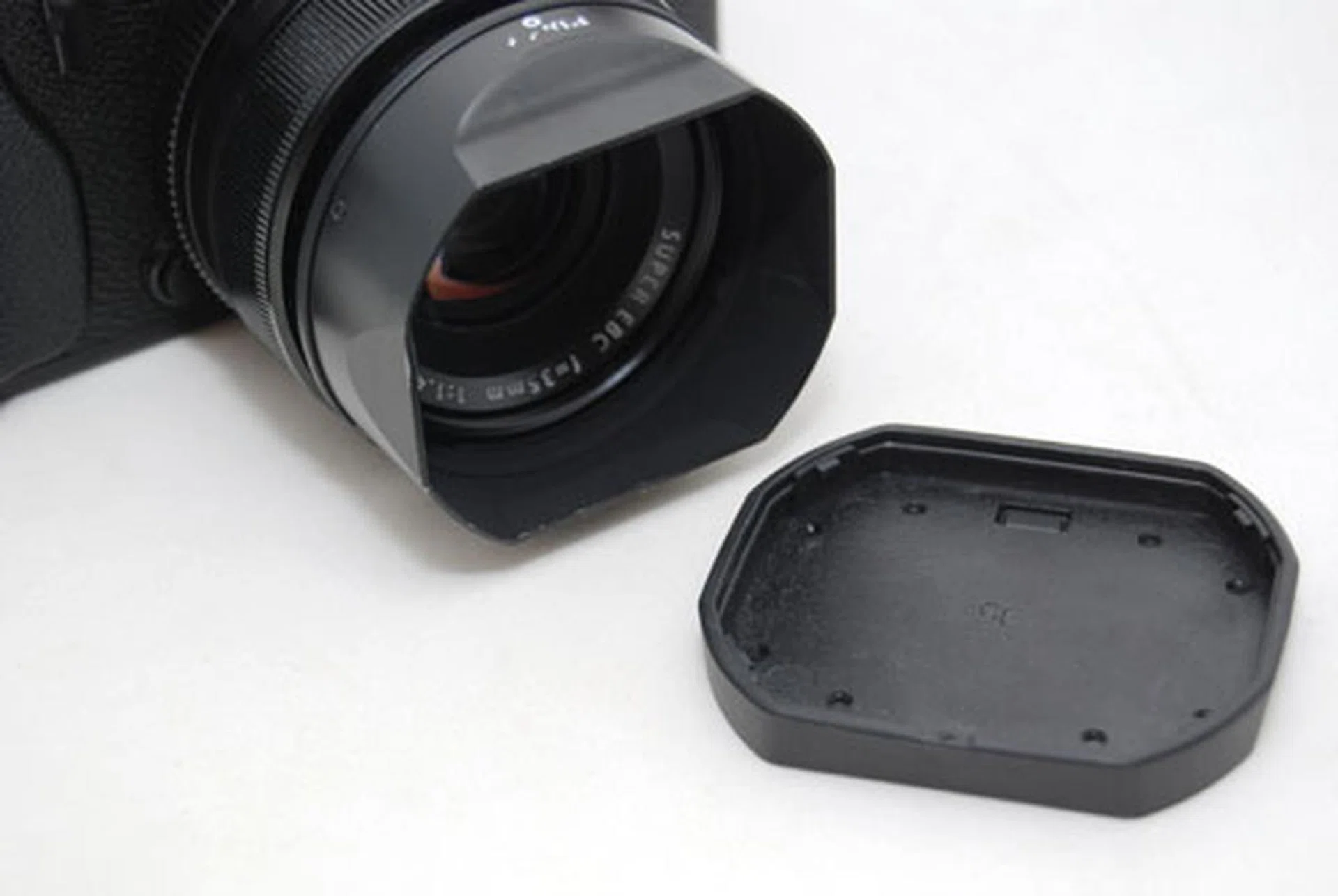 While the metal lens hoods are handsome, the rubber covers feel cheap and slip off easily.