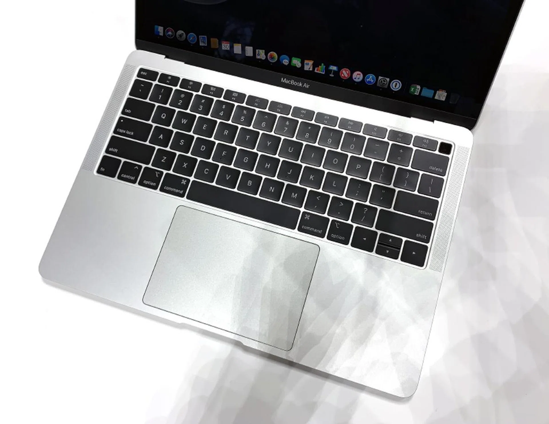 The keyboard uses Apple's third generation design. Note the Touch ID button to the top right.