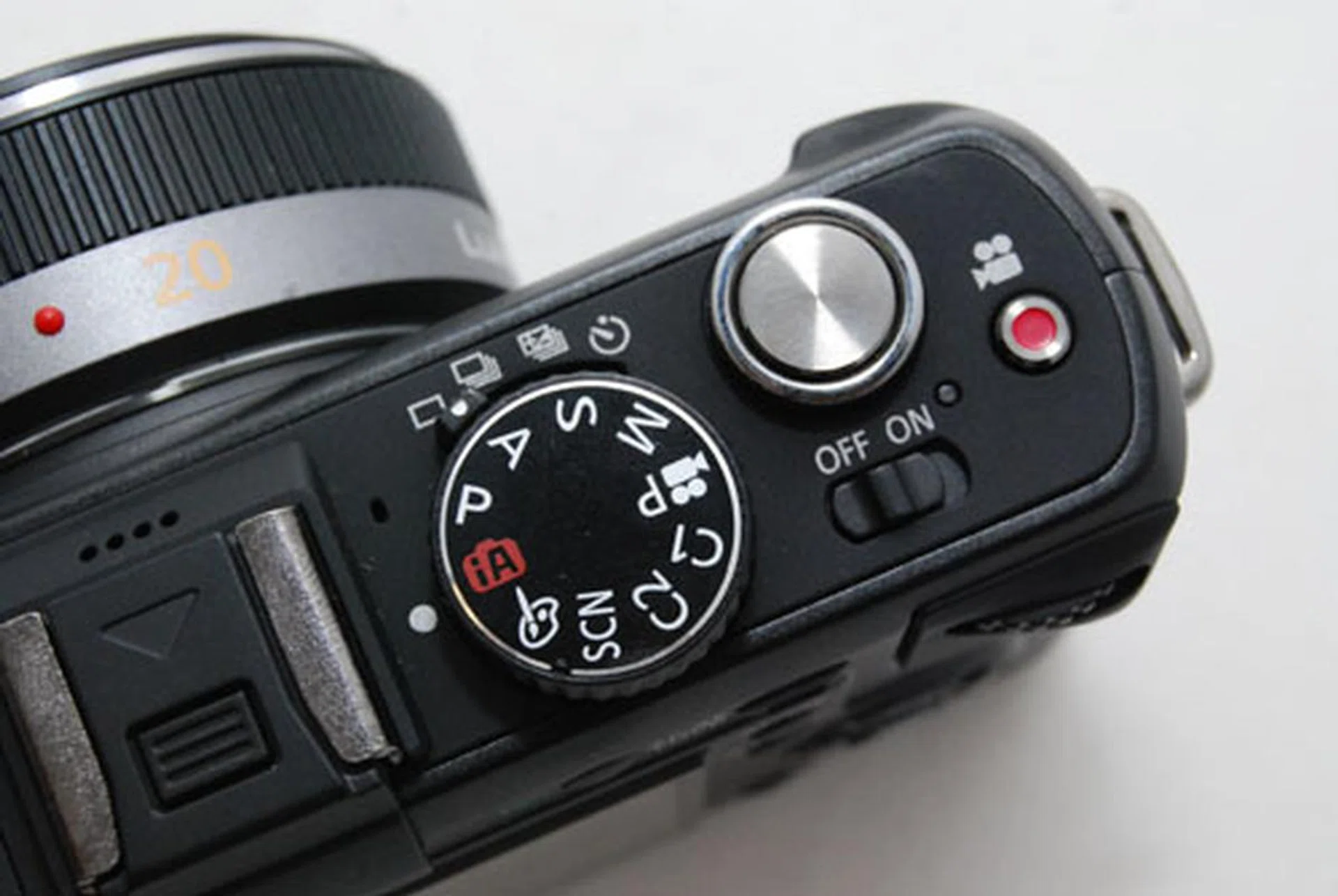 A handy video button next to the shutter release lets you record video immediately while in photo modes.