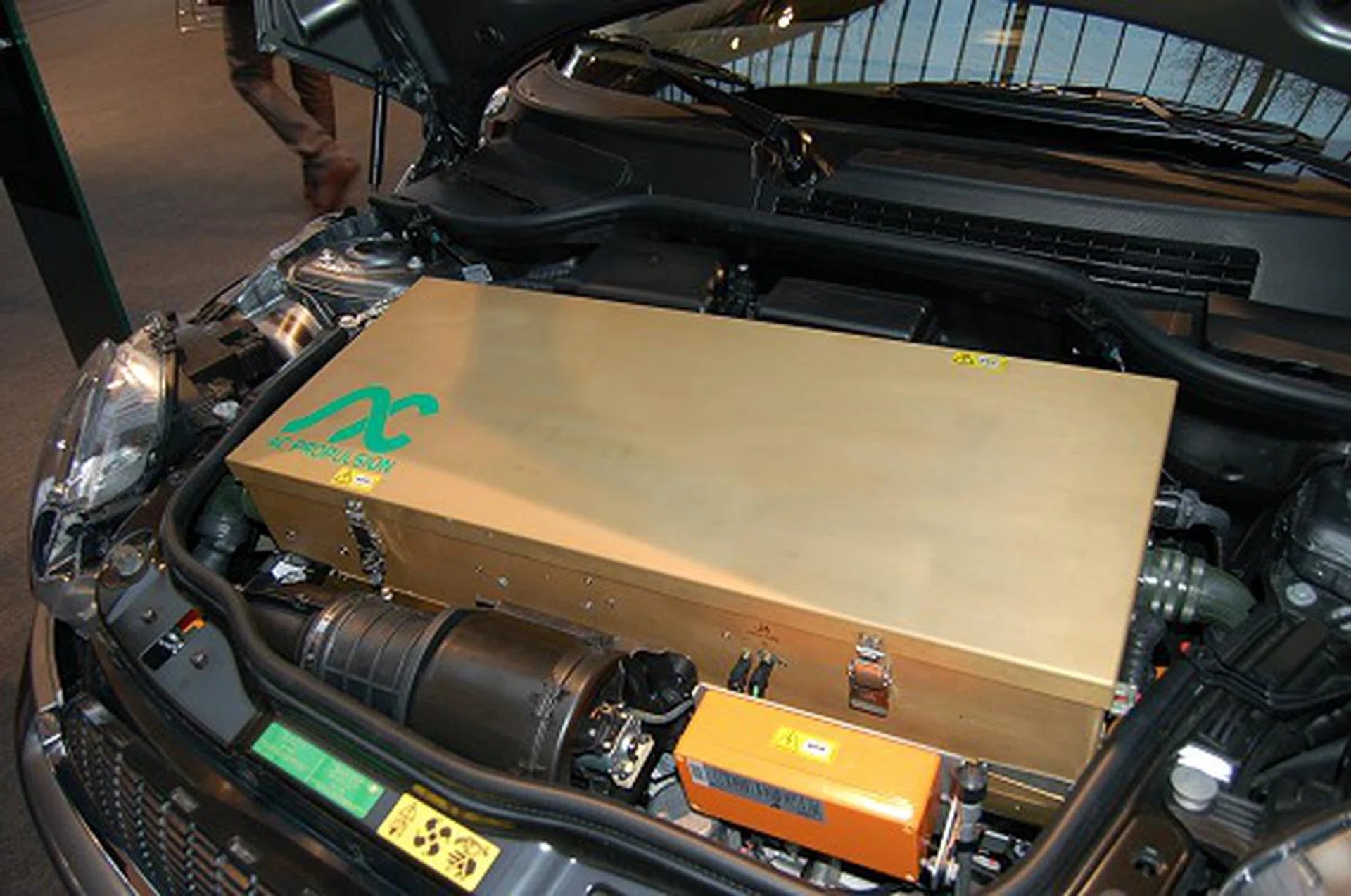  Here's a closer look at the boxy 'engine' from AC Propulsion. Car charging is done just like as if you were to plug an appliance to the wall socket.  