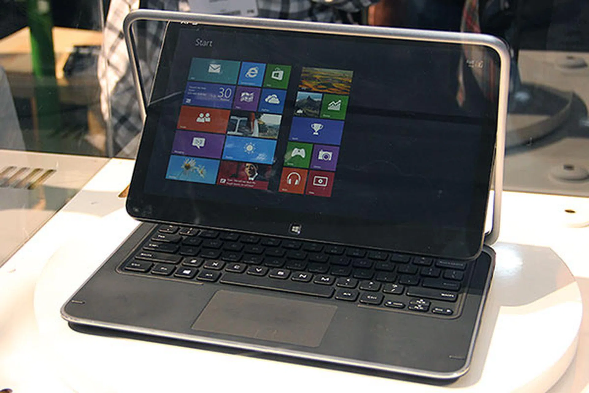 To convert from notebook to tablet mode, you swivel the screen around, and fold it down over the keyboard.