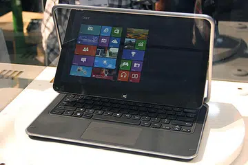 To convert from notebook to tablet mode, you swivel the screen around, and fold it down over the keyboard.