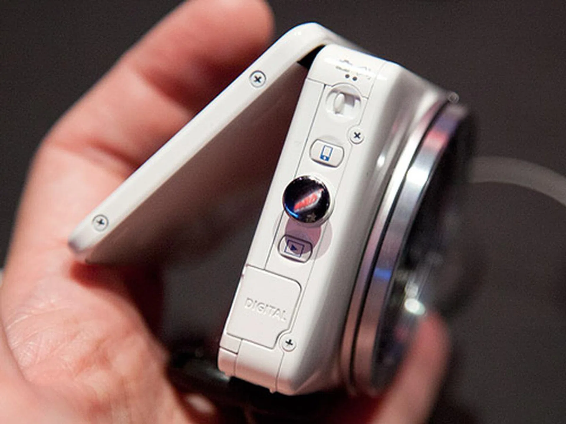 The switch on top lets you toggle between normal camera and Creative Shot modes. The button below it (with the iPhone-like icon) is the Mobile Device Connect Button while the button at the bottom lets you playback images and videos.