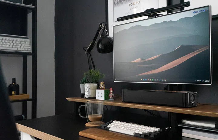 An under-monitor speaker like the Creative Stage SE can fit easily into your current workspace without any clutter. (Image source: Creative)