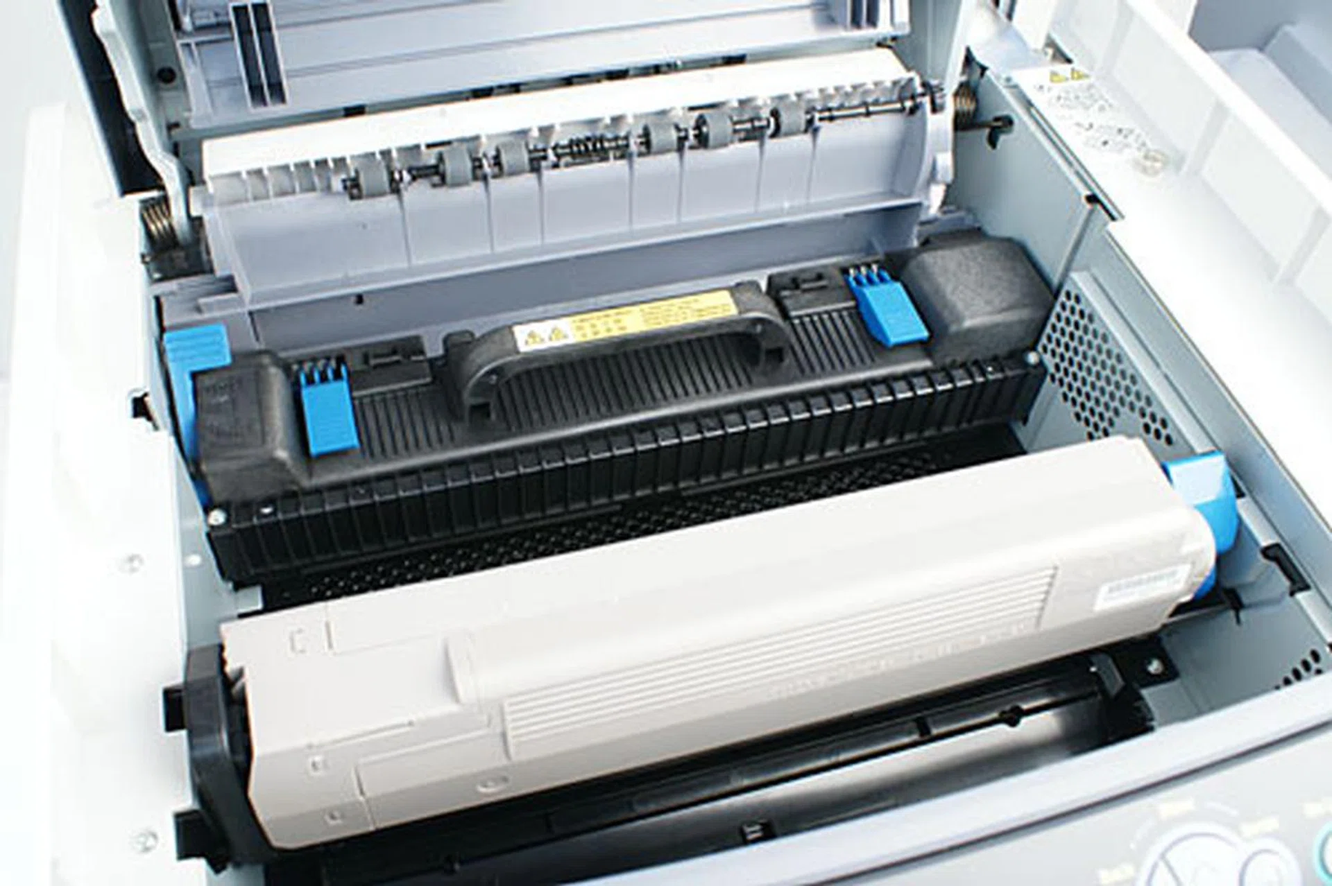 Lifting the top cover reveals the fuser unit (black contraption with handle) and the toner cartridge.