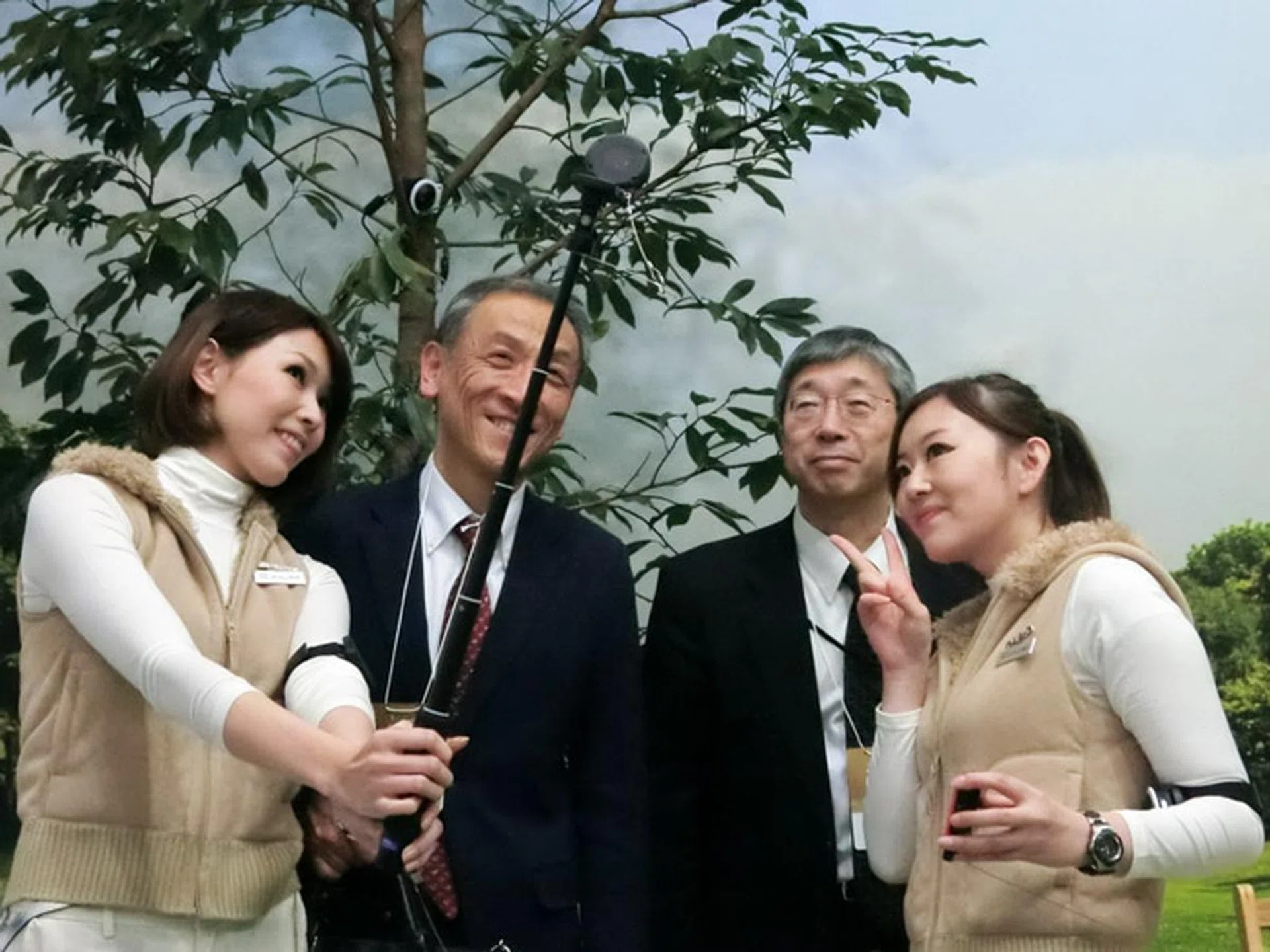 Visitors having a wefie taken with the booth babes.