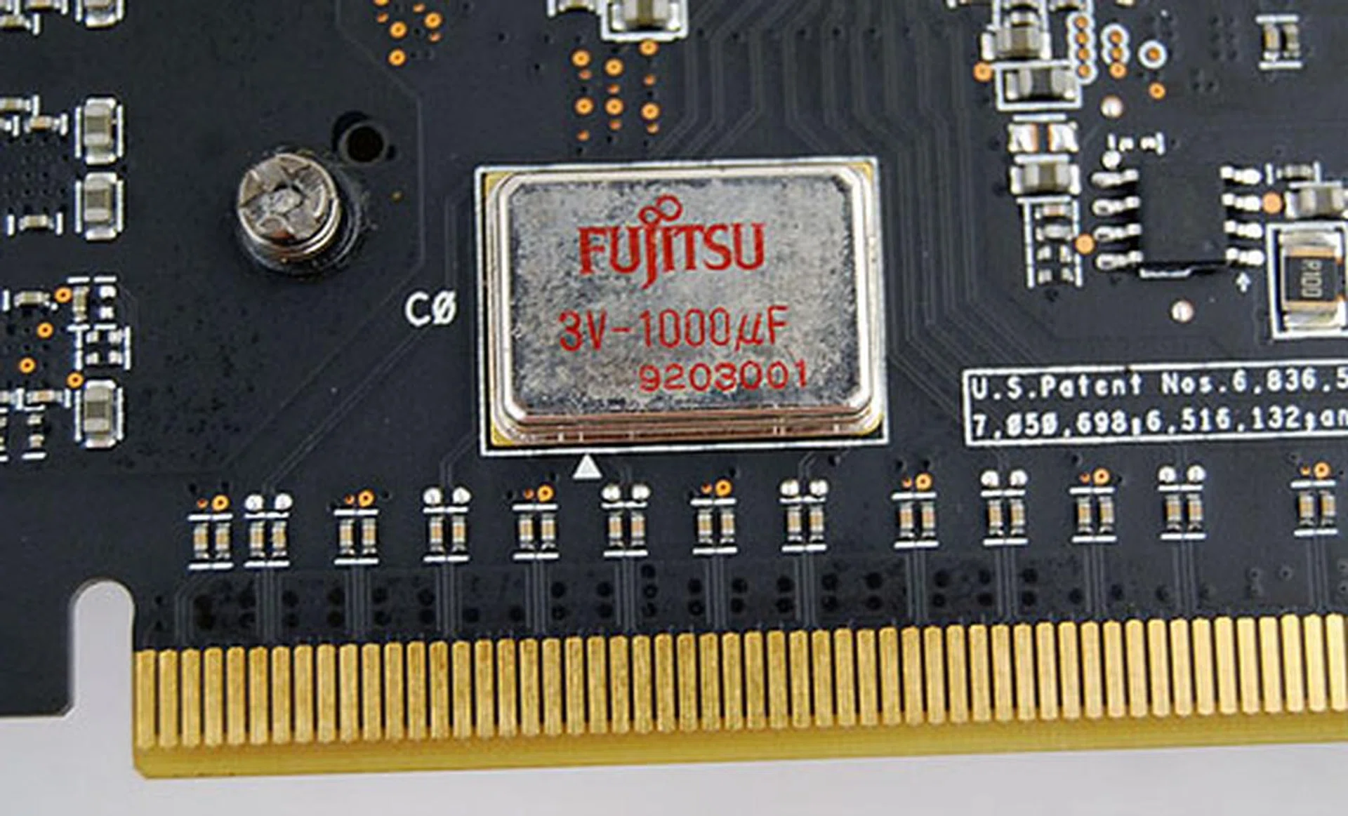 The ASUS EAH4890 Formula does away with the usual line of capacitors and opts instead for a single Fujitsu high-capacity 3v-1000uf capacitor.