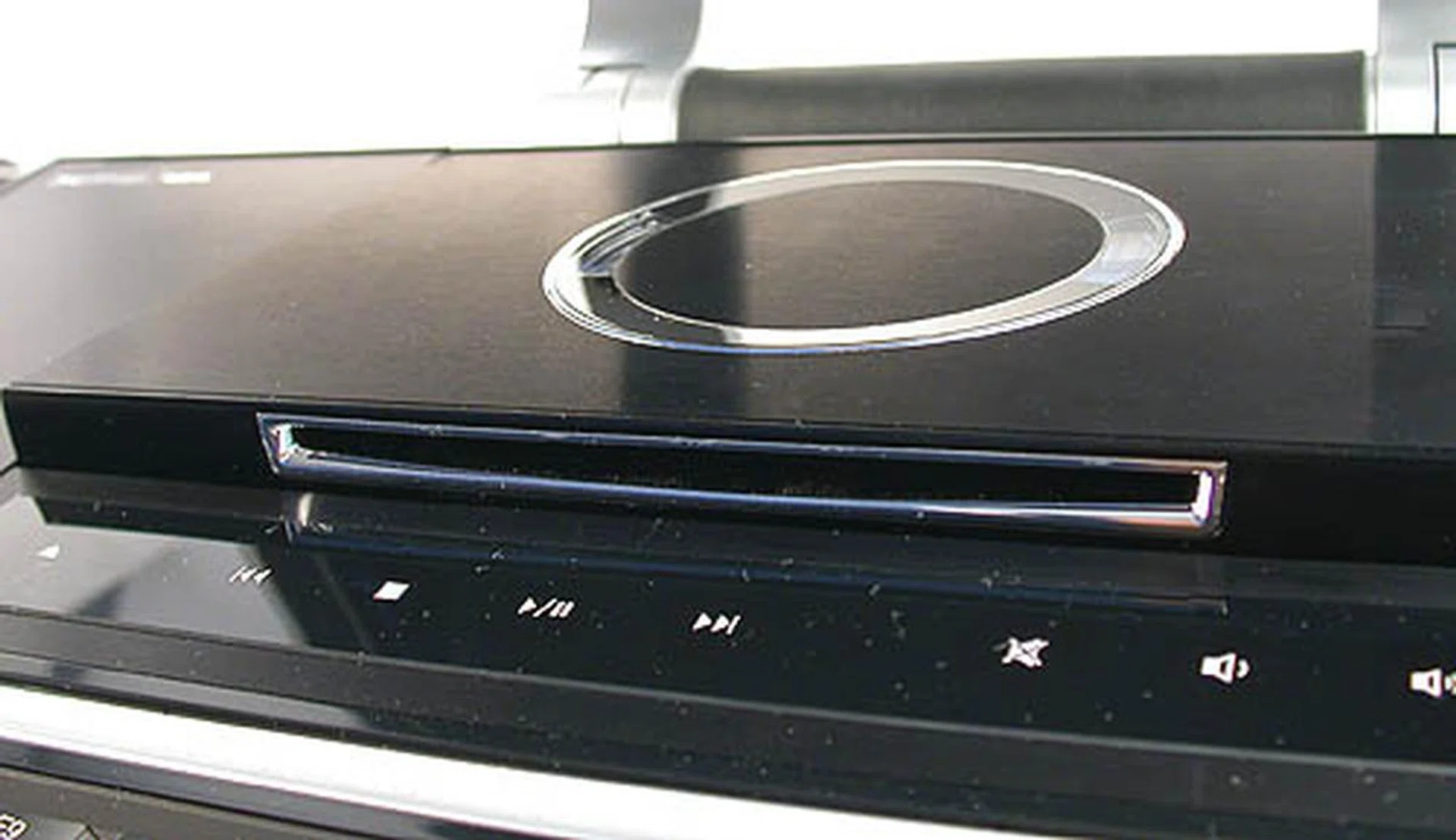 The DVD burner (Teac 8x DVD+-RW) pops out at a touch of the touchpad controls below it. It will also automatically close after a while. The controls below are very useful for playing your discs though we feel that you are more likely to use the remote control. 