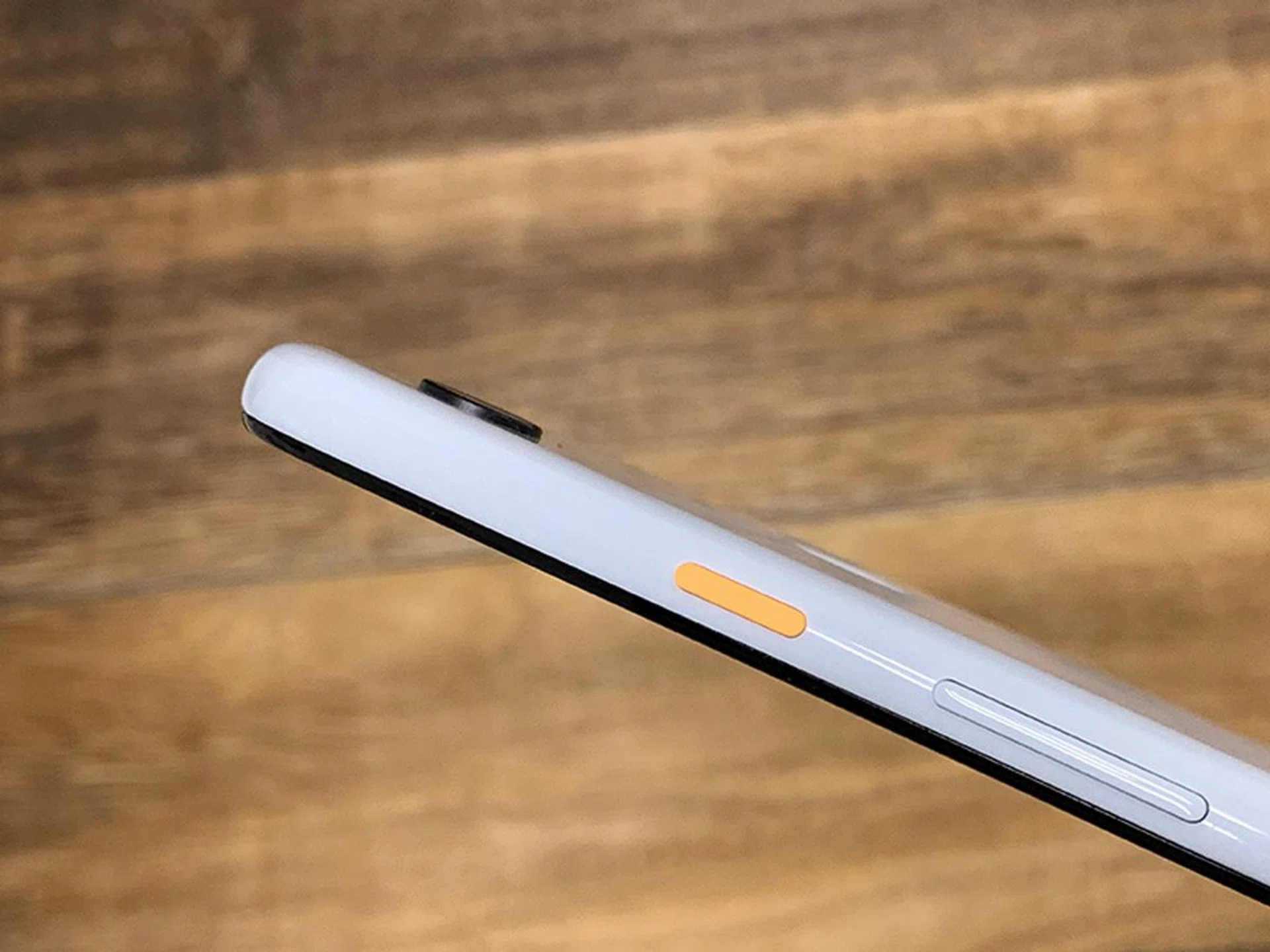 The white Pixel 3 XL has a lime green power button, but the white Pixel 3a XL has an orange power button.