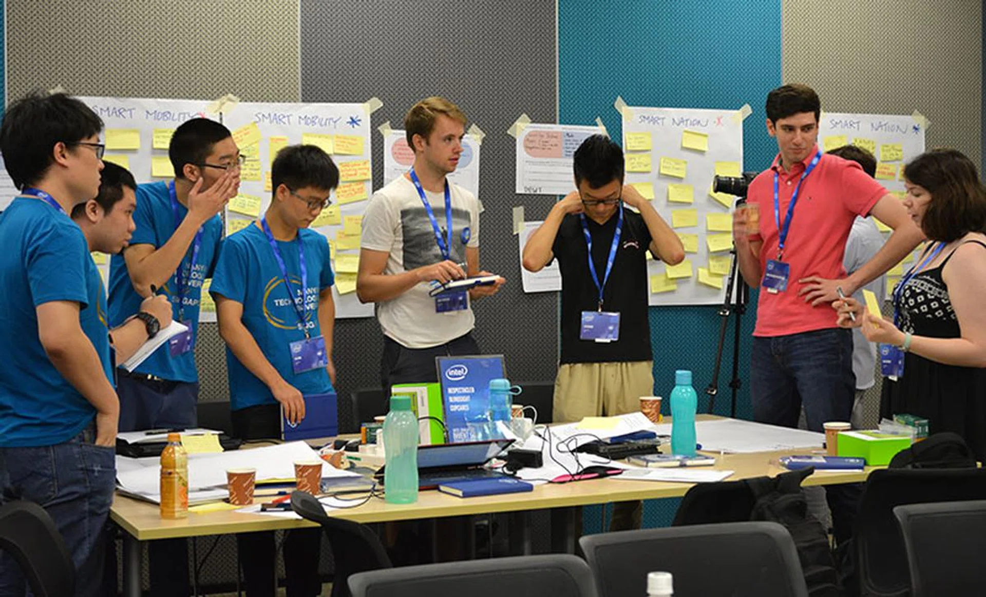 Let's all stand up so we can understand each other better. Teams CupCare (blue shirts) and BlindSight at work here.