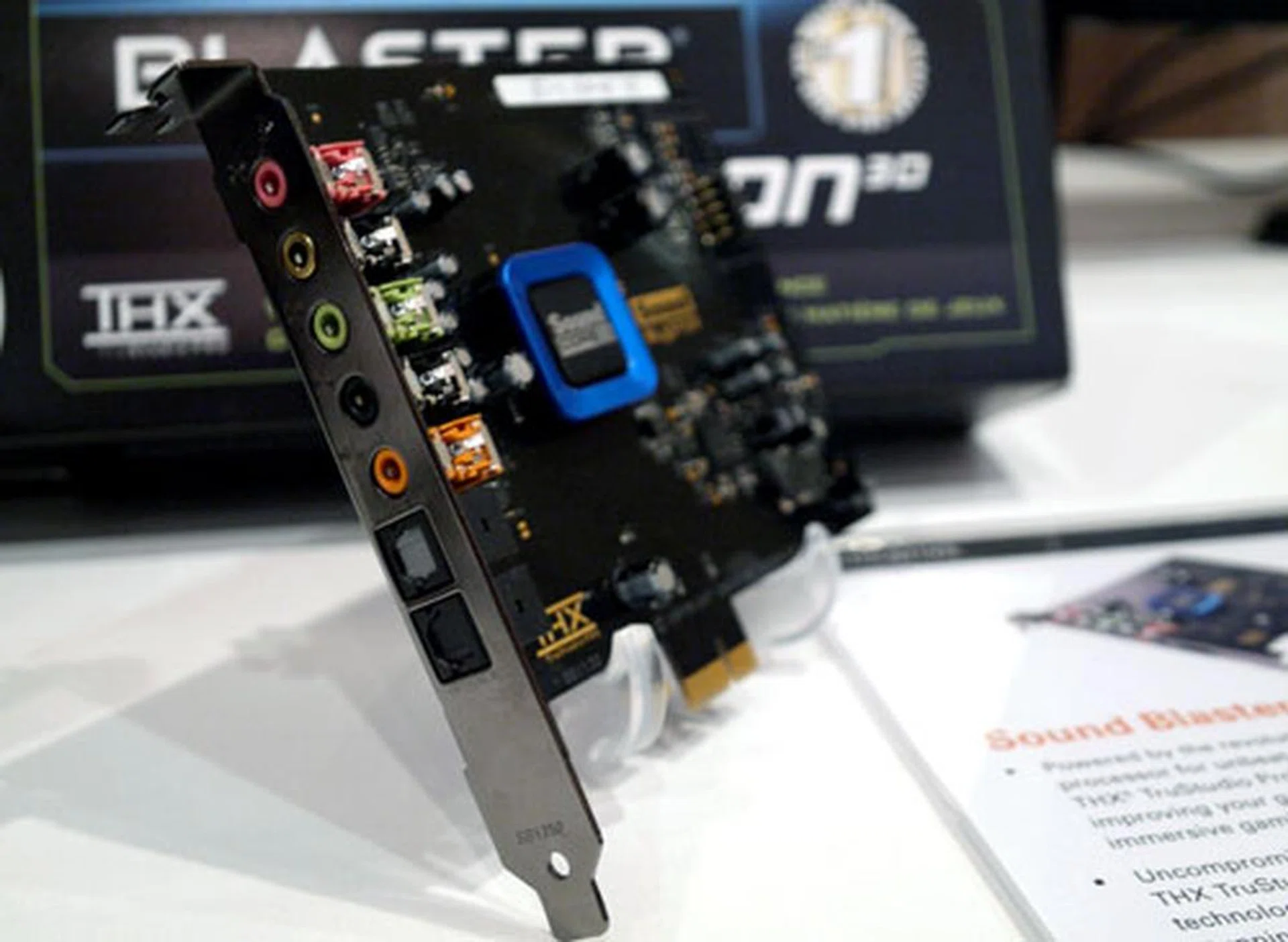 The PCIe edition offers a more extensive number of I/O jacks compared to its USB sibling. The amplified headphone outlet is highlighted in green, while the card's optical input and output ports are located at the lower end of the bracket.  