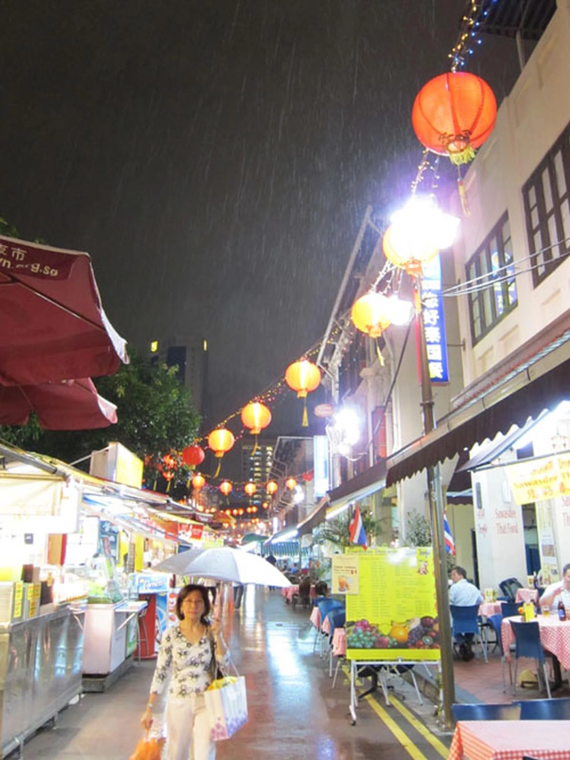 Even though f/2 gets you more light, 28mm is pretty wide - notice the sharp angles of the buildings to the right. Shot at f/2, 28mm, 1/15 sec, ISO1600. Click for the full resolution image (warning - large).
