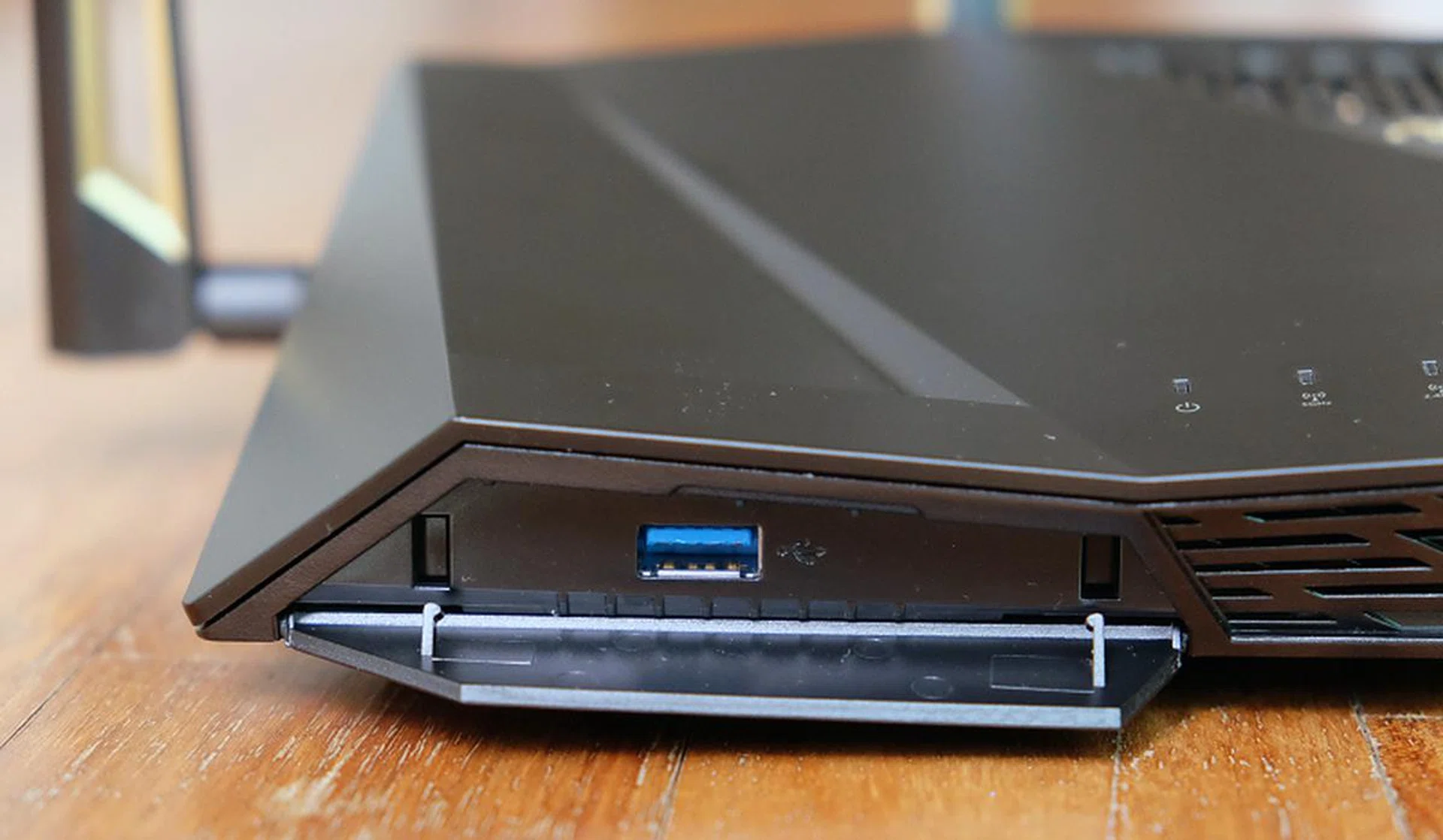 A USB 3.0 port is hidden at the front of the router under a dust cover.