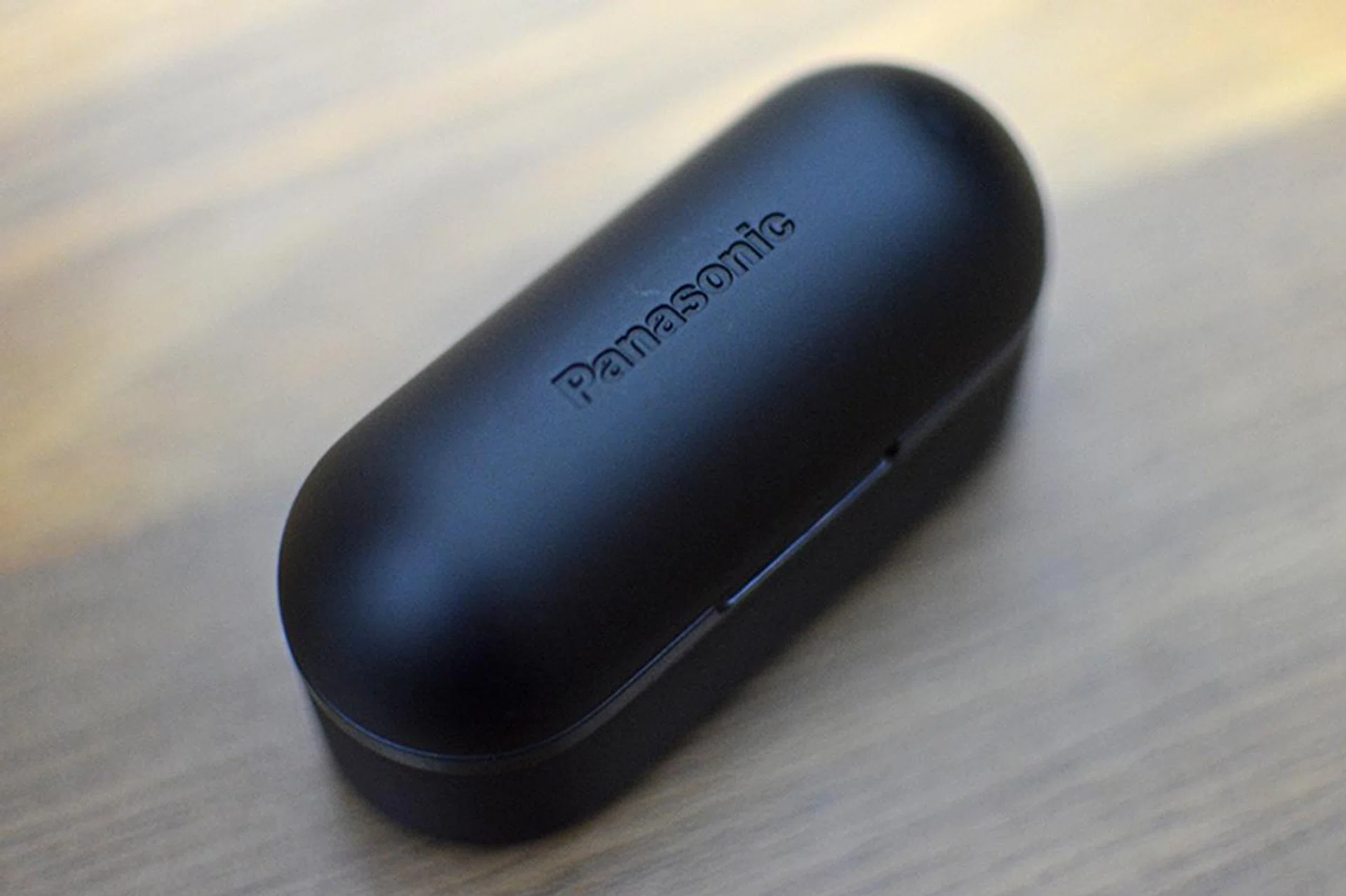 The embossed logo on the charging case's lid is barely visible.