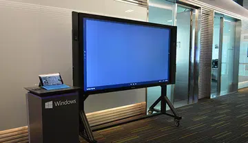 Shown here is the 84-inch Surface Hub beside the Surface Pro 3.