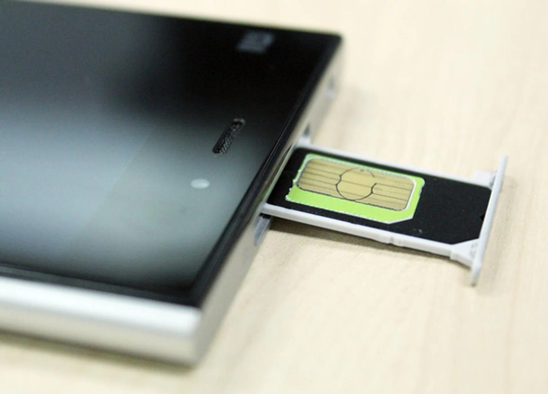 Most Android smartphones today use micro-SIM cards and the Xiaomi Mi 3 is an exception to the rule. It uses a standard sized SIM card. Seen here is a micro-SIM card in a black SIM card adapter.
