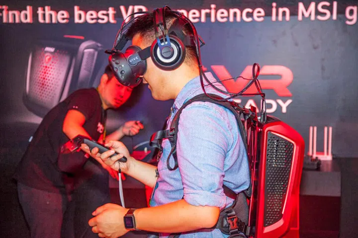 Wires from the headset runs behind your neck directly into the backpack PC. There are no dangling wires that can possibly cause you to trip. Also, you can see air vents on the side of the PC which provides airflow to keep components cool and preventing excessive heat from reaching your back.